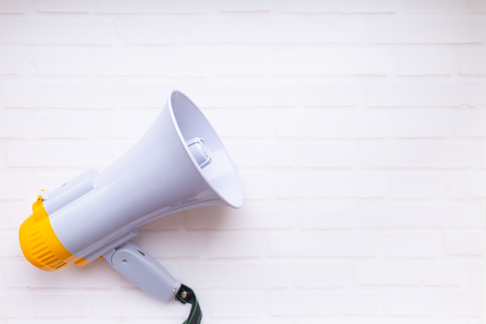 Loudspeaker on brick wall background